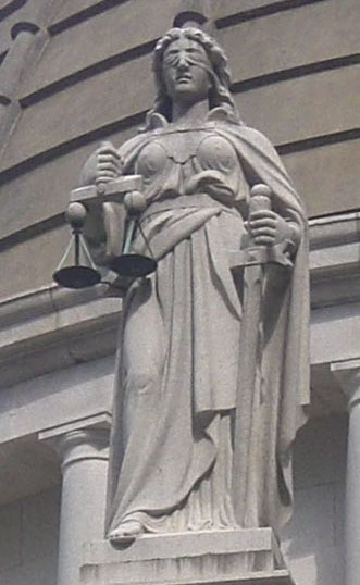 Statue of Justice in Hong Kong. The scales of justice are to weigh the evidence